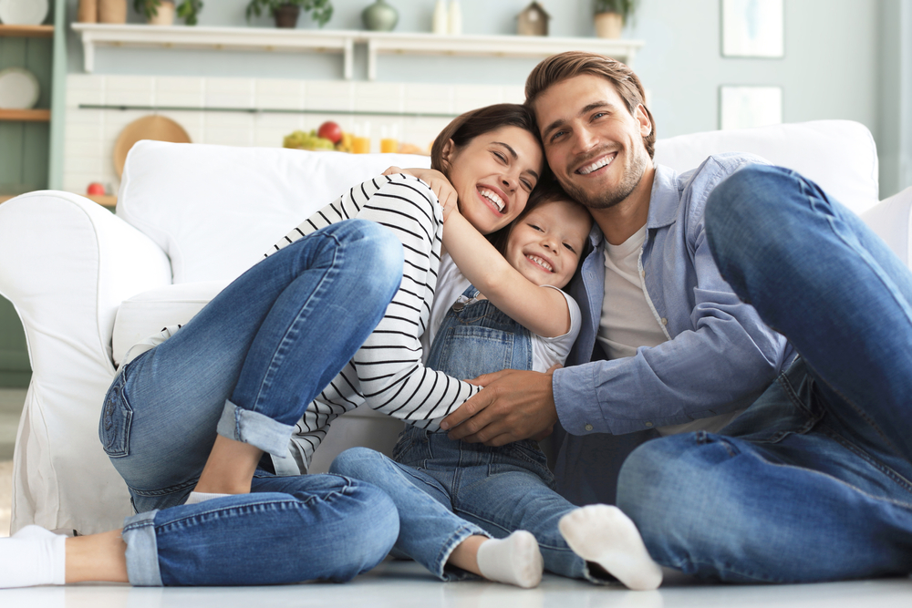 Happy family smiling together healthy smiles family dentist after Teeth Cleaning in The Woodlands TX