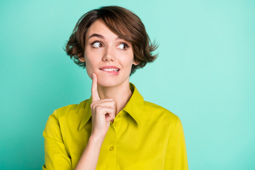 Woman thinking about improving her smile with All-on-4 in Woodlands TX