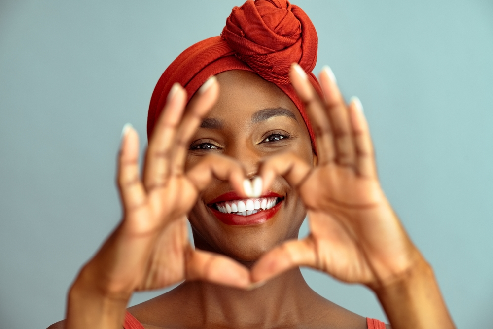 Young woman smiling with bright teeth, showing great satisfaction with the dental results