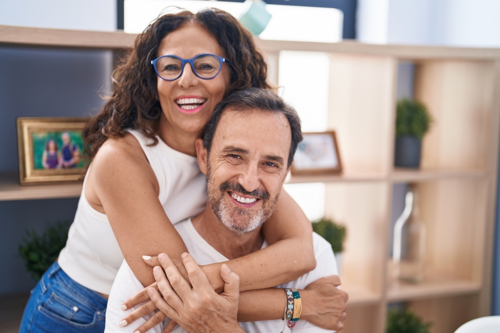 Happy couple smiling together healthy smiles family dentistry and All-on-4s in Woodlands TX