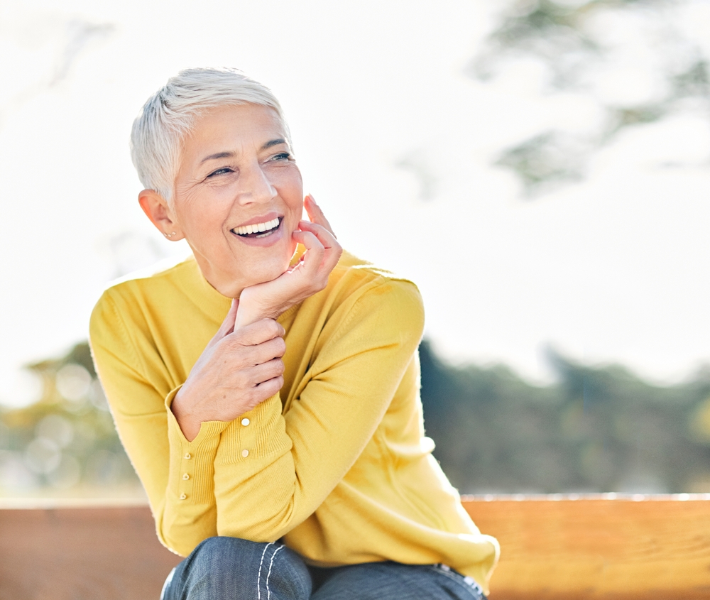 woman smiling with healthy teeth after Full Dentures in The Woodlands TX