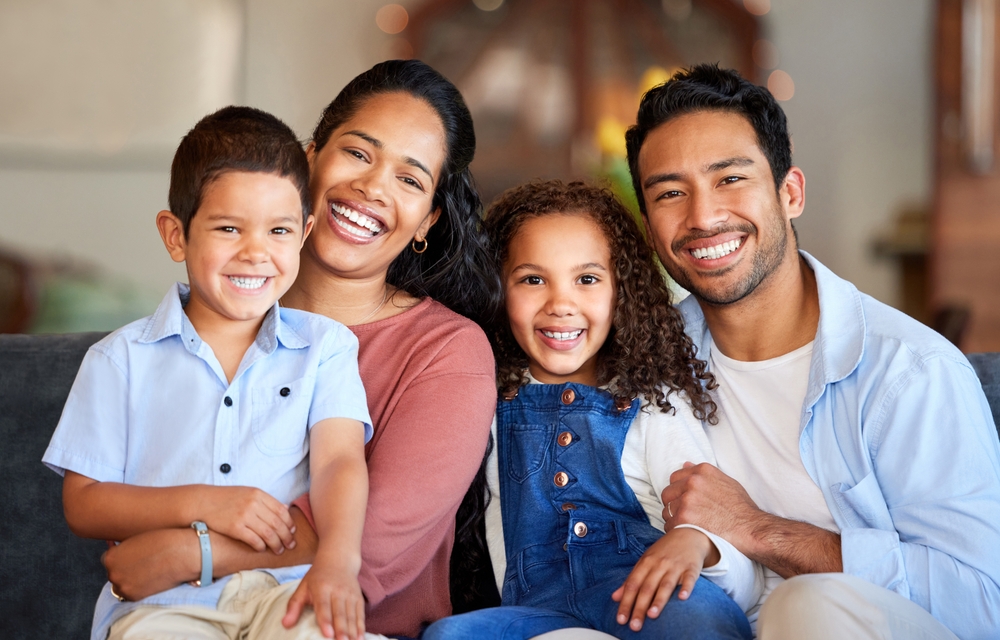 Happy parents and children smiling family dentistry The Woodlands TX