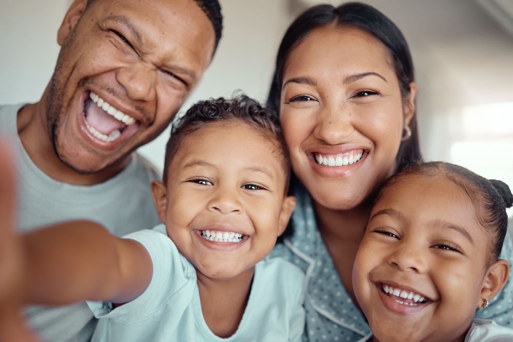 Happy family relaxing together healthy and clean smiles family dentist Woodlands TX