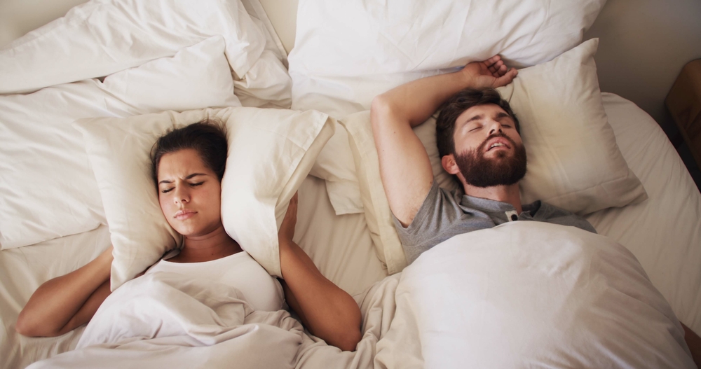 Couple sleeping with snoring issue sleep apnea treatment Woodlands TX