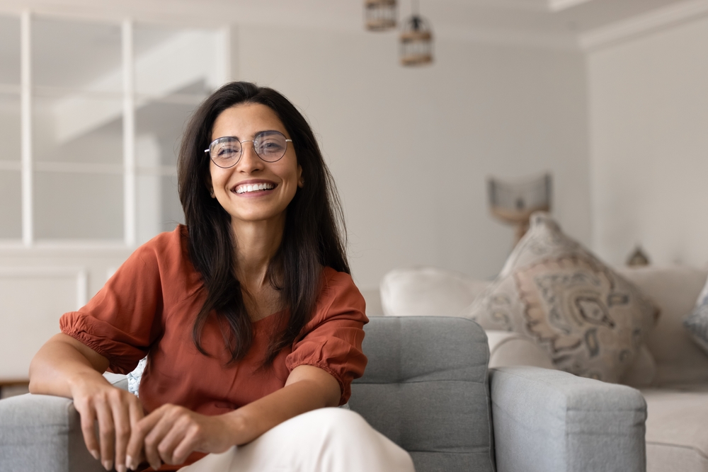 Young woman smiling at home after dental care The Woodlands TX