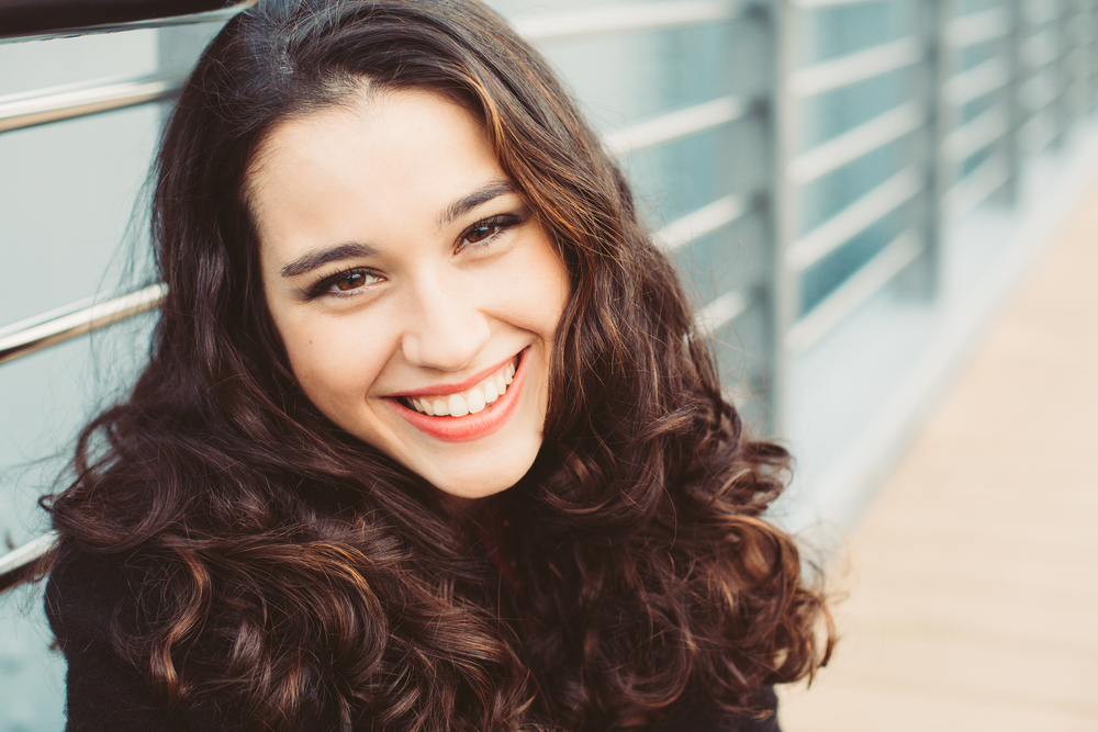 Young woman smiling with bright healthy smile after Dental Exams in Woodlands TX
